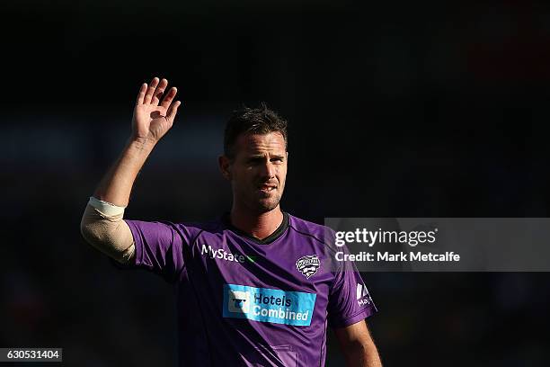 Shaun Tait of the Hurricanes stretches before the Big Bash League match between the Hobart Hurricanes and Sydney Stars at Blundstone Arena on...