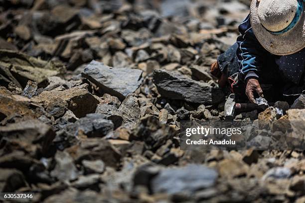 Miner works at a gold mine in La Rinconada, the highest permanent settlement in the world, in Puno, Peru on November 1, 2016. Miners work under a...
