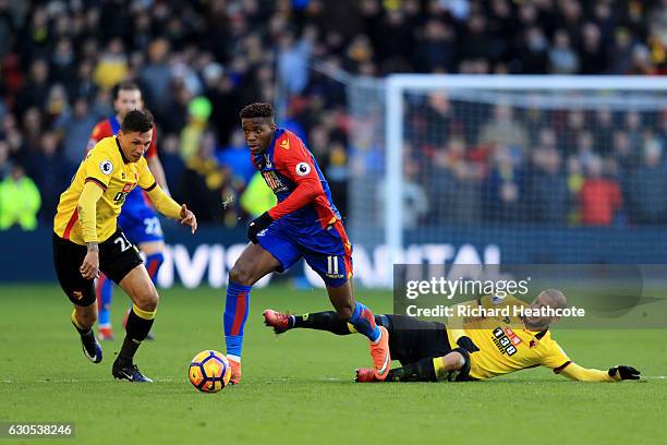 Wilfried Zaha of Crystal Palace battles for the ball with Adlene Guedioura of Watford and Jose Holebas of Watford during the Premier League match...