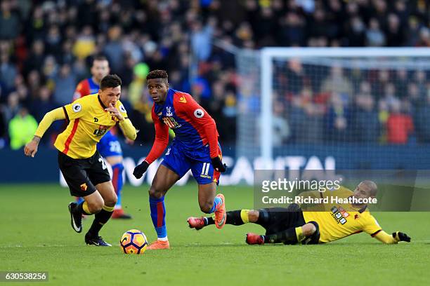 Wilfried Zaha of Crystal Palace battles for the ball with Adlene Guedioura of Watford and Jose Holebas of Watford during the Premier League match...