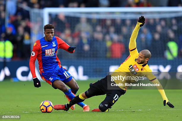 Wilfried Zaha of Crystal Palace battles for the ball with Adlene Guedioura of Watford during the Premier League match between Watford and Crystal...