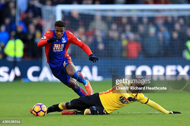 Wilfried Zaha of Crystal Palace battles for the ball with Adlene Guedioura of Watford during the Premier League match between Watford and Crystal...