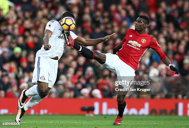 Victor Anichebe of Sunderland and Paul Pogba of Manchester United compete for the ball during the Premier League match between Manchester United and...