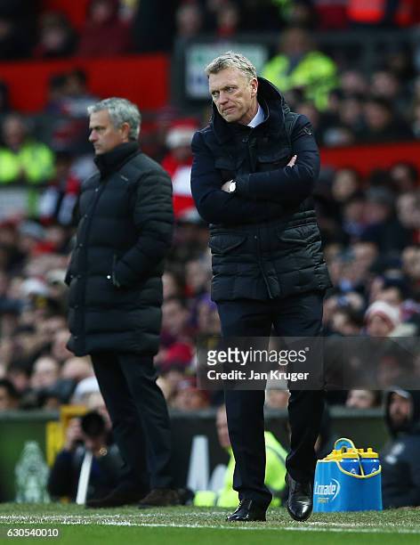 David Moyes, Manager of Sunderland and Jose Mourinho, Manager of Manchester United look on during the Premier League match between Manchester United...