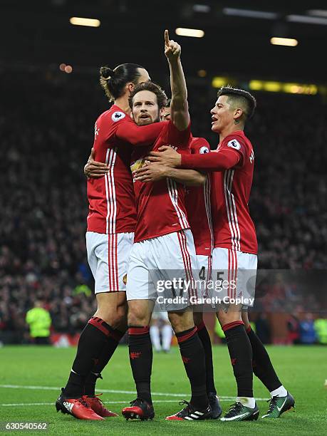 Daley Blind of Manchester United celebrates with teammates after scoring the opening goal during the Premier League match between Manchester United...