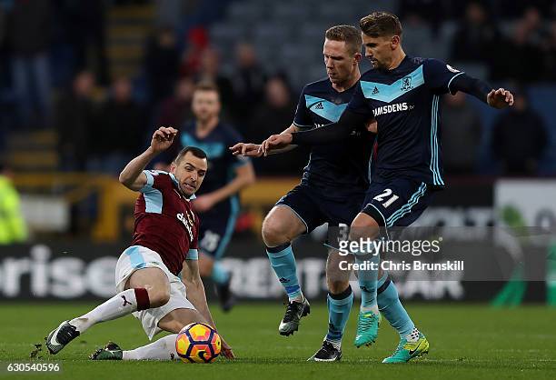Dean Marney of Burnley slides in ahead of Gaston Ramirez of Middlesbrough during the Premier League match between Burnley and Middlesbrough at Turf...