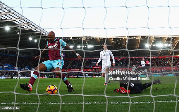 Andre Ayew of West Ham United scores the opening goal during the Premier League match between Swansea City and West Ham United at Liberty Stadium on...