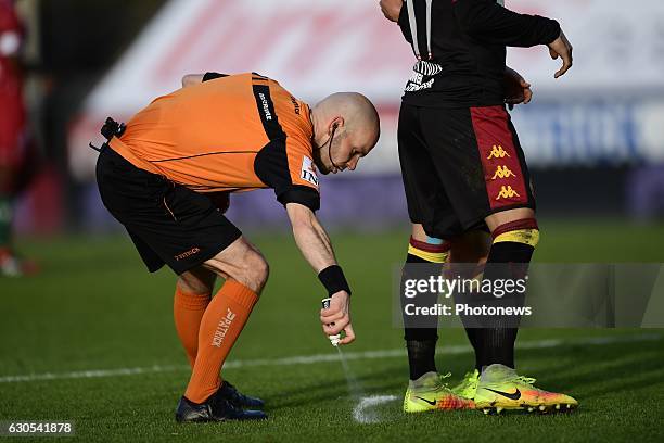 Referee Sebastien Delferiere sprays paint on the field during the Jupiler Pro League match between SV Zulte Waregem and KV Mechelen on December 26,...