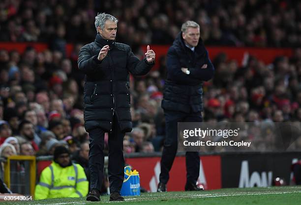 Jose Mourinho, Manager of Manchester United directs his players as David Moyes, Manager of Sunderland looks on during the Premier League match...