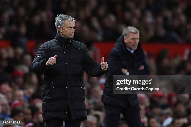 Jose Mourinho, Manager of Manchester United directs his players as David Moyes, Manager of Sunderland looks on during the Premier League match...