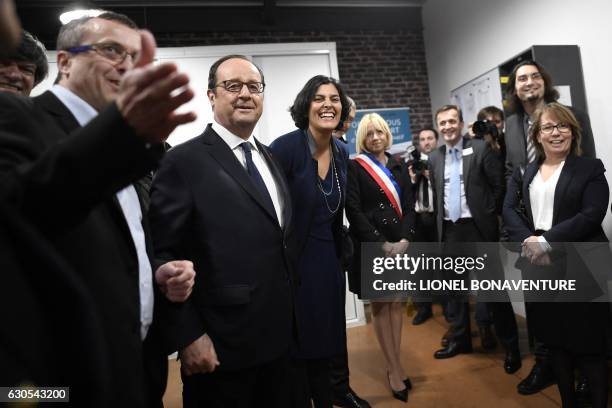 French President Francois Hollande listens to Vincent Bronze , the General director of French elevators company ETNA France, next to French Labour...