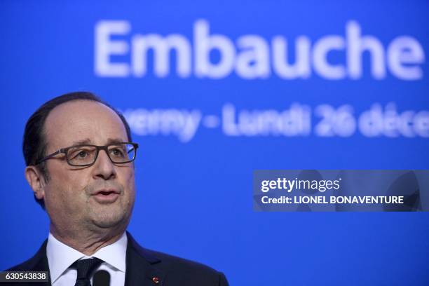 French President Francois Hollande delivers a speech during his visit of the French elevators company ETNA France on December 26, 2016 in Taverny,...