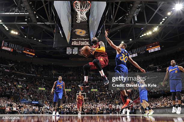 Kyrie Irving of the Cleveland Cavaliers drives to the basket against the Golden State Warriors on December 25, 2016 at Quicken Loans Arena in...