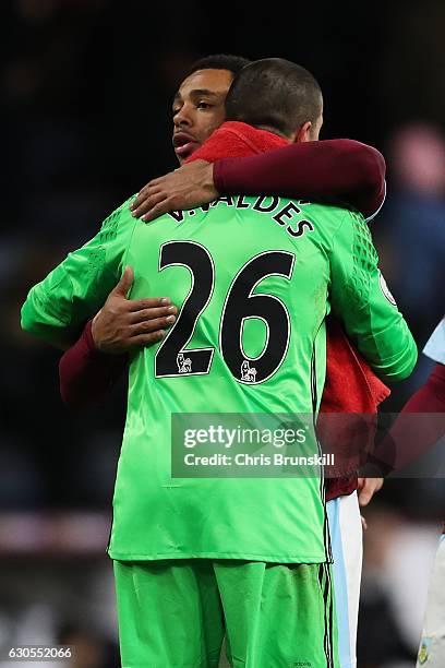 Andre Gray of Burnley and Victor Valdes of Middlesbrough embrace following the Barclays Premier League match between Burnley and Middlesbrough on...