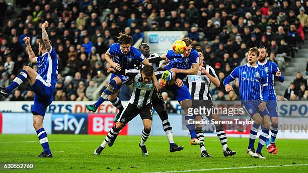 Dwight Gale of Newcastle United battles with Sam Hutchinson of Sheffield Wednesday and Tom Lees of Sheffield Wednesday with no foul given during the...