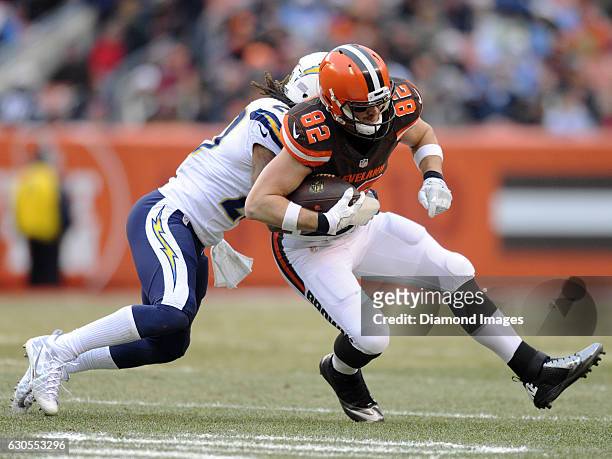 Tight end Gary Barnidge of the Cleveland Browns is tackled by defensive back Dwight Lowery of the San Diego Chargers during a game on December 24,...