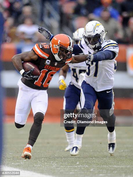 Wide receiver Andrew Hawkins of the Cleveland Browns carries the ball downfield as he stiff-arms linebacker Jatavis Brown of the San Diego Chargers...