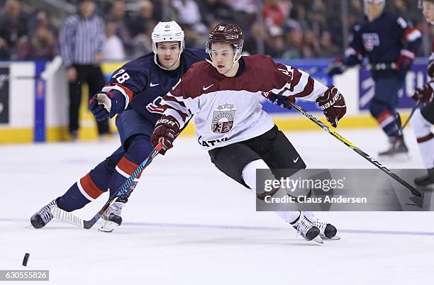 Jack Roslovic of Team USA skates against Martins Dzierkals of Team Latvia during a 2017 IIHF World Junior Hockey Championship game at the Air Canada...