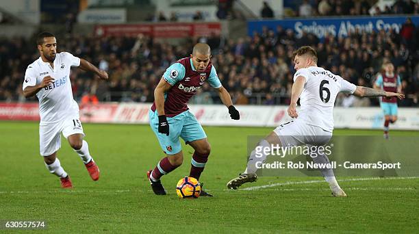 West Ham United's Sofiane Feghouli takes on Swansea City's Alfie Mawson during the Premier League match between Swansea City and West Ham United at...