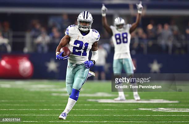Ezekiel Elliott of the Dallas Cowboys runs for a touchdown as teammate Dez Bryant celebrates as the Cowboys play the Detroit Lions during the first...