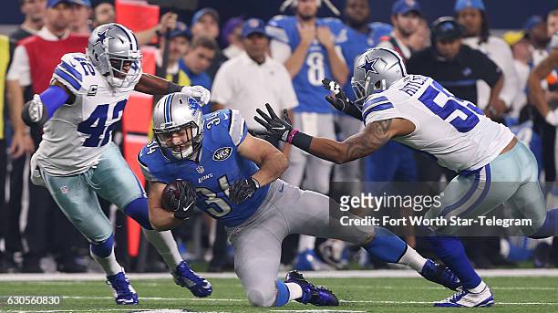 Detroit Lions fullback Zach Zenner runs between Dallas Cowboys strong safety Barry Church and Anthony Hitchens as the Cowboys take on the Detroit...