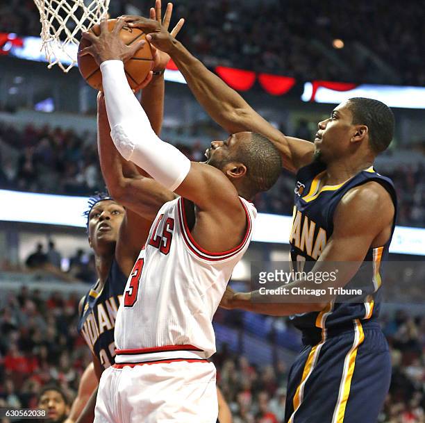 Chicago Bulls guard Dwyane Wade is pressured by Indiana Pacers center Myles Turner , left, and Indiana Pacers guard Glenn Robinson III during the...