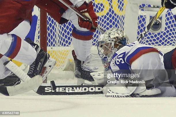 Russia goalie Ilya Samsonov saves a goal by deflecting the puck while laying flat on his stomach. Team Canada vs Team Russia in 3rd period action of...