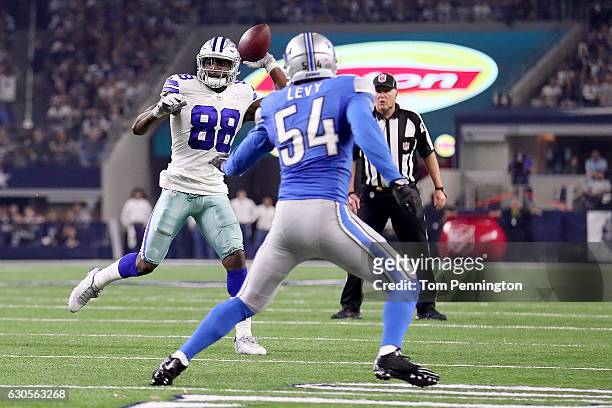 Dez Bryant of the Dallas Cowboys throws a touchdown pass to Jason Witten of the Dallas Cowboys against DeAndre Levy of the Detroit Lions in the third...