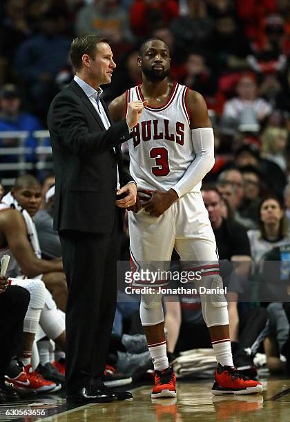 Head coach Fred Hoiberg of the Chicago Bulls talks with Dwyane Wade during a game against the Indiana Pacers at the United Center on December 26,...