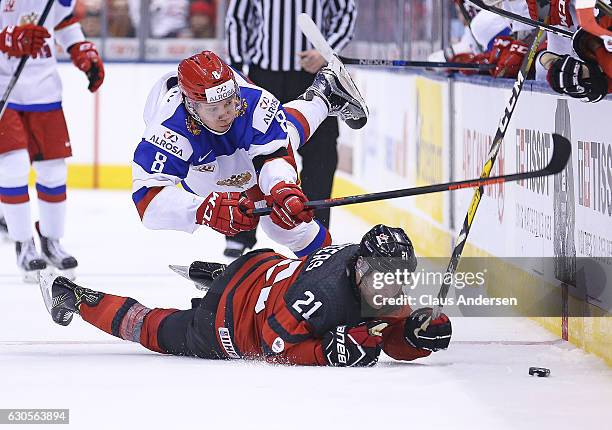 Kirill Urakov of Team Russia battles Blake Speers of Team Canada during a game at the the 2017 IIHF World Junior Hockey Championships at the Air...