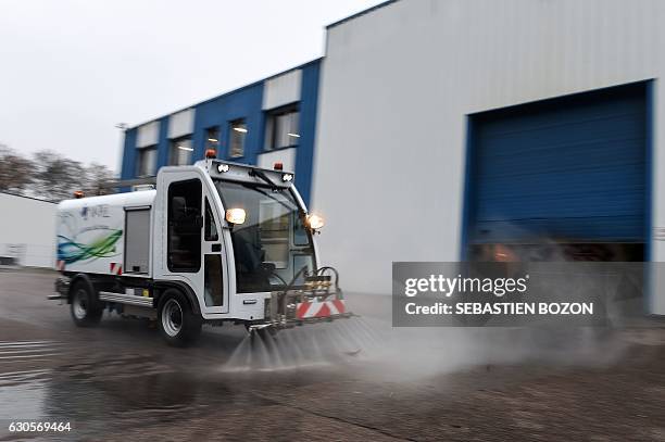 Man drives the LEV1200 electric washer at the Val air workshop on November 24, 2016 in La Cote. Mayor of Paris' determination to ban diesel from the...