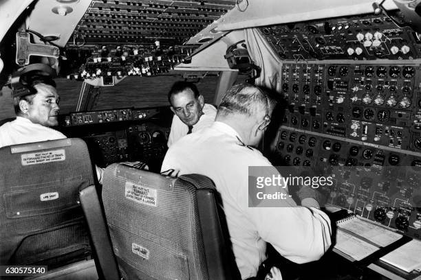 Pan American Airways pilots are seen in the cockpit of the Boeing 747 at London Heathrow airport, on January 22, 1970 after its first commercial...