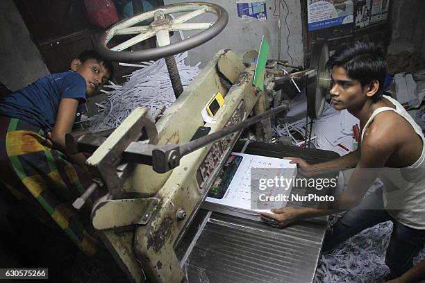 Bangladeshi workers passing very busy time at a printing-house to make New Year 2017 calendars in Dhaka, Bangladesh on December 27, 2016.