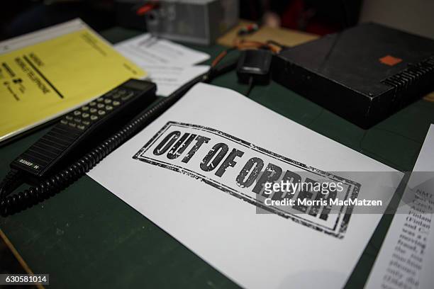 Out of Order' sign is placed next to an old cell phone at the 33rd Chaos Communication Congress on its opening day on December 27, 2016 in Hamburg,...