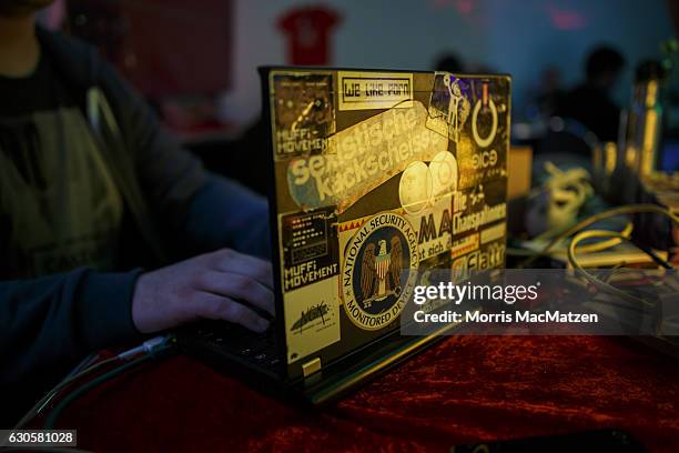 Participant poses with a laptop during the 33rd Chaos Communication Congress on its opening day on December 27, 2016 in Hamburg, Germany. The annual...