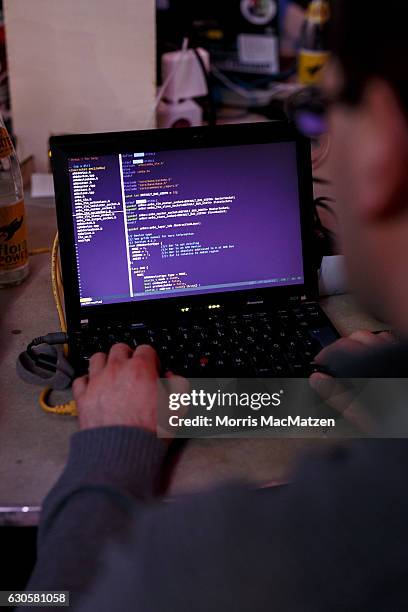 Participant poses with his laptop during the 33rd Chaos Communication Congress on its opening day on December 27, 2016 in Hamburg, Germany. The...