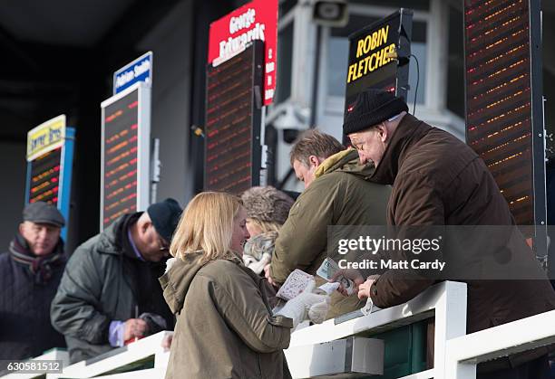 Woman places a bet ahead of the first race during the 2016 Coral Welsh Grand National at Chepstow Racecourse on December 27, 2016 in Chepstow, Wales....