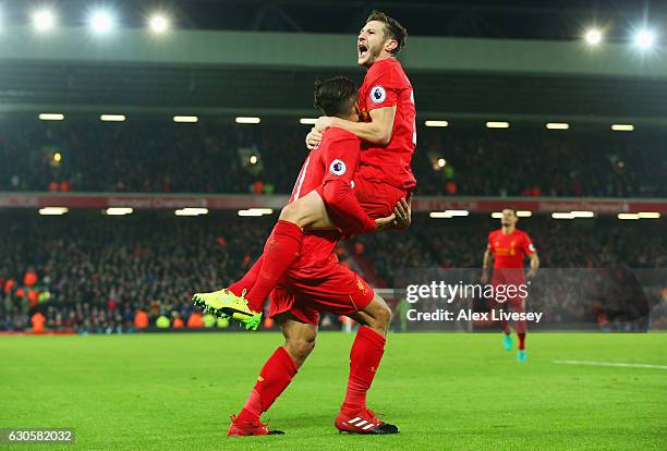 Roberto Firmino of Liverpool celebrates with Adam Lallana as he scores their second goal during the Premier League match between Liverpool and Stoke...