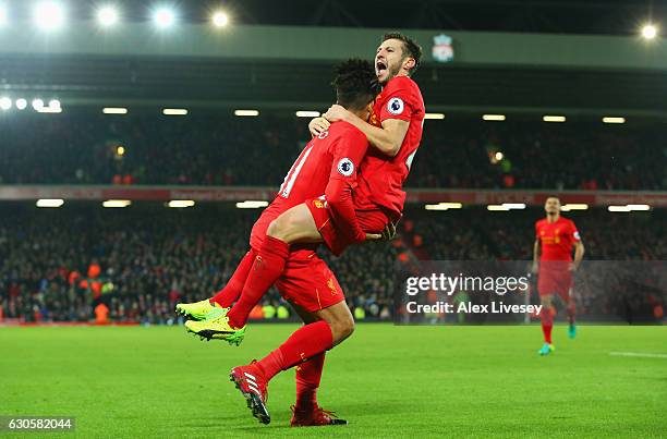 Roberto Firmino of Liverpool celebrates with Adam Lallana as he scores their second goal during the Premier League match between Liverpool and Stoke...