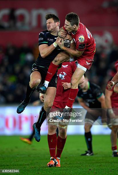 Scarlets fullback Liam Williams and Dan Biggar of the Ospreys compete for a high ball during the Guinness Pro 12 match between Ospreys and Scarlets...