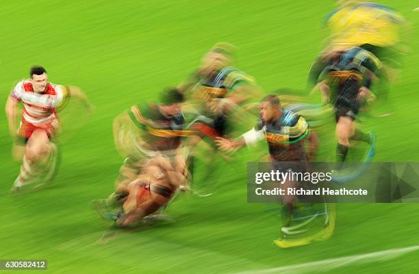 Charlie Matthews of Harlequins hands off to team mate Kyle Sinckler during the Aviva Premiership Big Game 9 match between Harlequins and Gloucester...