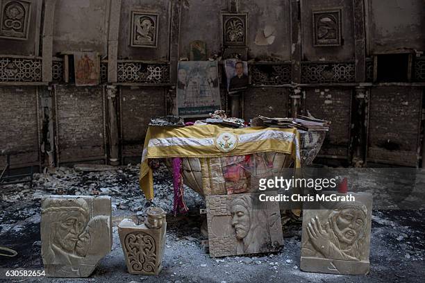Salvaged books and other items are seen placed around the altar of a church burned and destroyed by ISIL during their occupation of the predominantly...