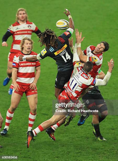 Marland Yarde of Harlequins jumps for the ball with James Hook and Jonny May of Gloucester during the Aviva Premiership Big Game 9 match between...