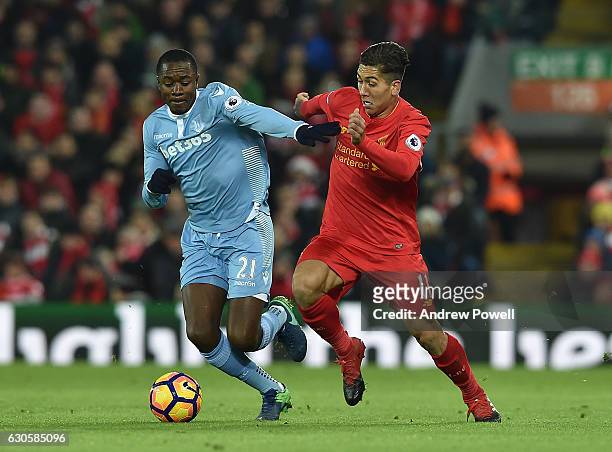 Roberto Firmino of Liverpool with Giannelli Imbula during the Premier League match between Liverpool and Stoke City at Anfield on December 27, 2016...