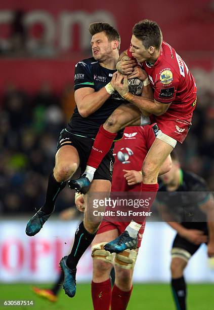 Scarlets fullback Liam Williams and Dan Biggar of the Ospreys compete for a high ball during the Guinness Pro 12 match between Ospreys and Scarlets...