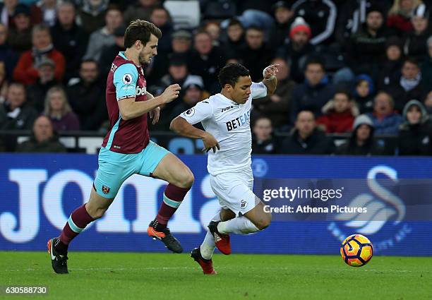 Jefferson Montero of Swansea City FC is closely marked by Havard Nordtveit of West Ham United during the Premier League match between Swansea City...