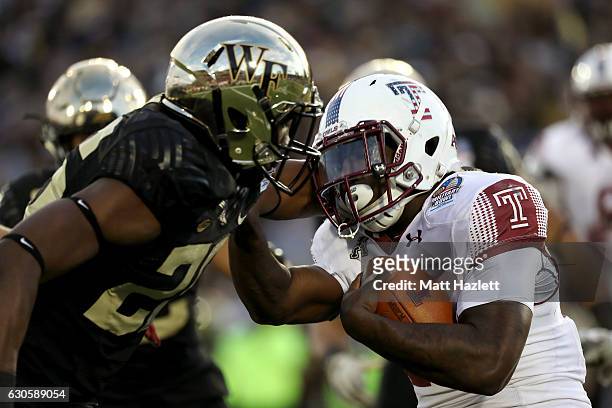 Running back Ryquell Armstead of the Temple Owls carries the ball against linebacker Thomas Brown of the Wake Forest Demon Deacons in the second...