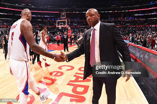 Doc Rivers of the Los Angeles Clippers high fives Marreese Speights of the Los Angeles Clippers during the game against the San Antonio Spurs on...