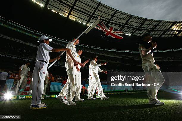 Jackson Bird, Matt Renshaw and Usman Khawaja of Australia walk under the flag of Australia as they walk onto the field during day three of the Second...