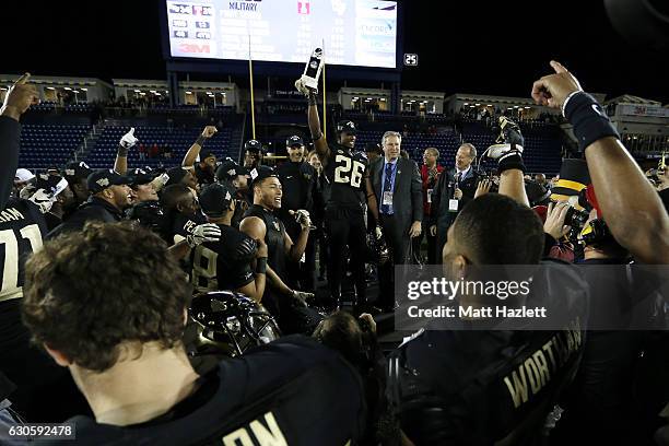 Linebacker Thomas Brown of the Wake Forest Demon Deacons celebrates with teammates after defeating the Temple Owls 34-26 in the Military Bowl at...